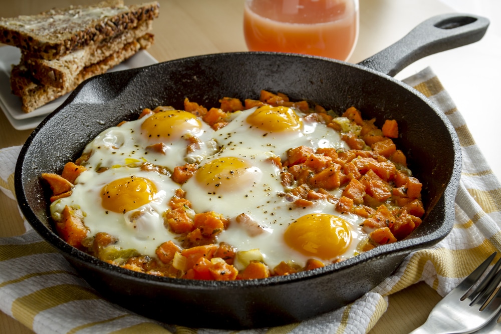 Eggs and yams on cast iron skillet